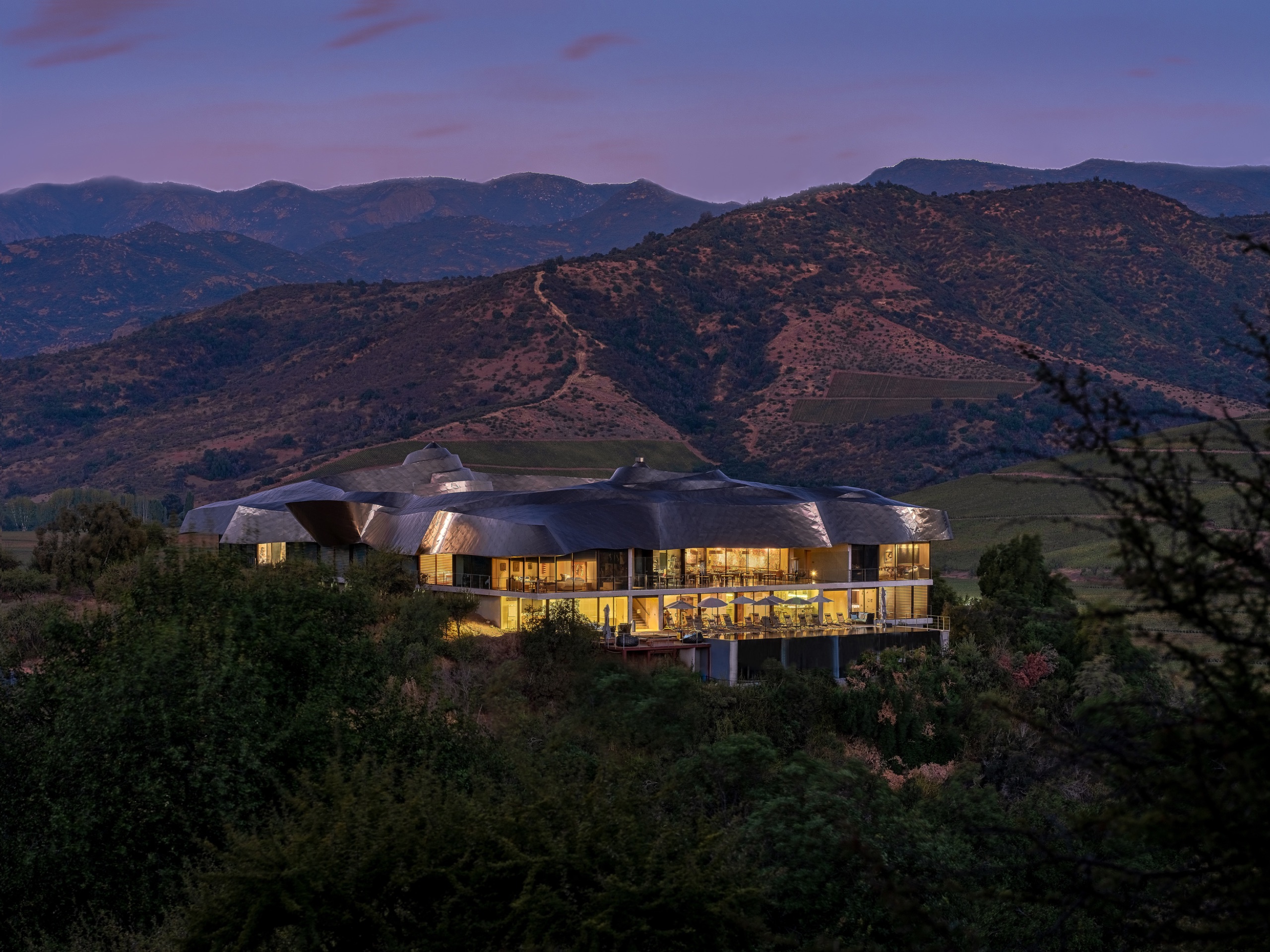 Vik retreat at golden hour, architecture folded into the hillside